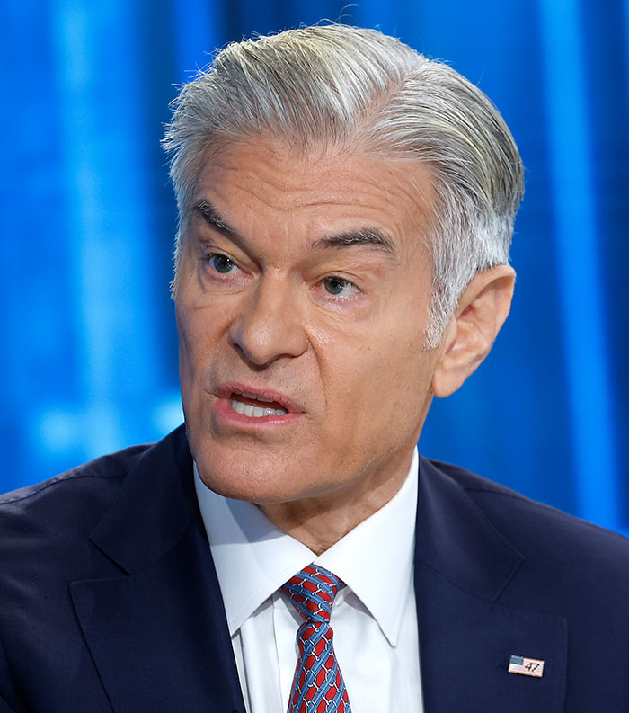 Close-up of a man in a suit speaking against a blue background, representing most disliked stars of this year.