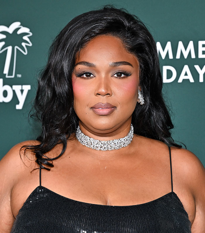 Female celebrity posing in a black dress and diamond choker at an event, featured among most disliked stars this year