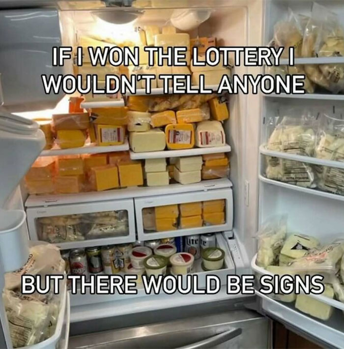 Refrigerator fully stocked with various cheeses and snacks, showcasing a wild dude fridge concept.