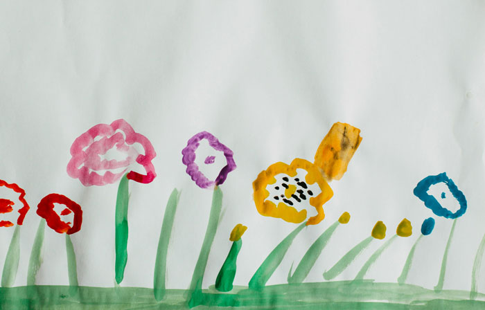 Child's watercolor painting of colorful flowers in the woods, reflecting nature's calming effect after sleepless days outdoors.