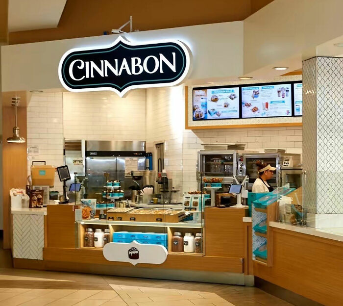 Cinnabon store interior with employee behind counter amid controversy involving racist incident and GoFundMe campaign. Cinnabon store interior with employee behind counter amid controversy involving racist incident and GoFundMe campaign.