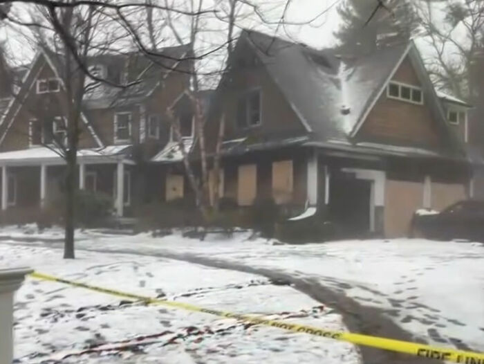 Snow-covered multi-million dollar mansion with police tape around the property after tragic accident involving sorority girl.