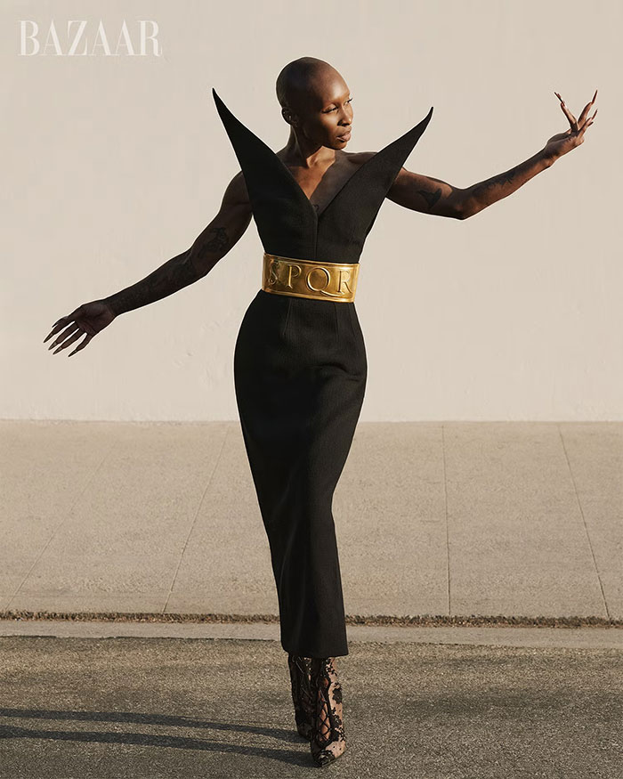 Cynthia Erivo poses in a striking black dress with a gold belt on a magazine cover amid Wicked For Good success. Cynthia Erivo poses in a striking black dress with a gold belt on a magazine cover amid Wicked For Good success.