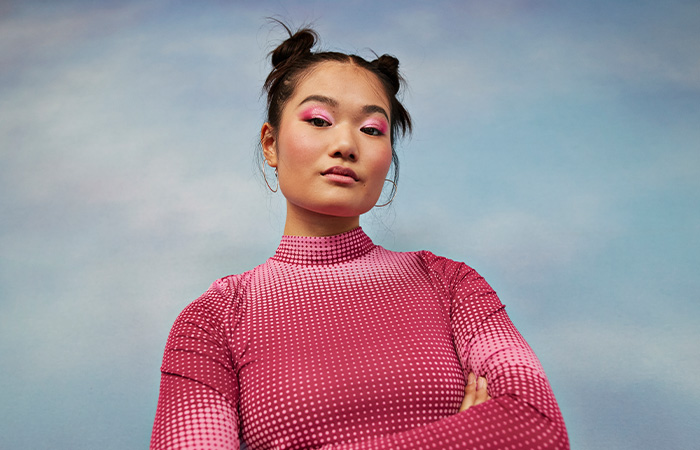 Confident young woman with stylish hair and bold makeup representing what men find attractive in women traits.