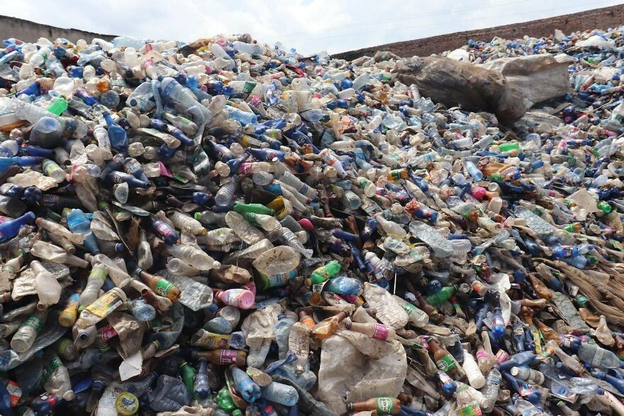 Huge landfill filled with plastic bottles and waste, illustrating pollution in some of the dirtiest countries in the world.