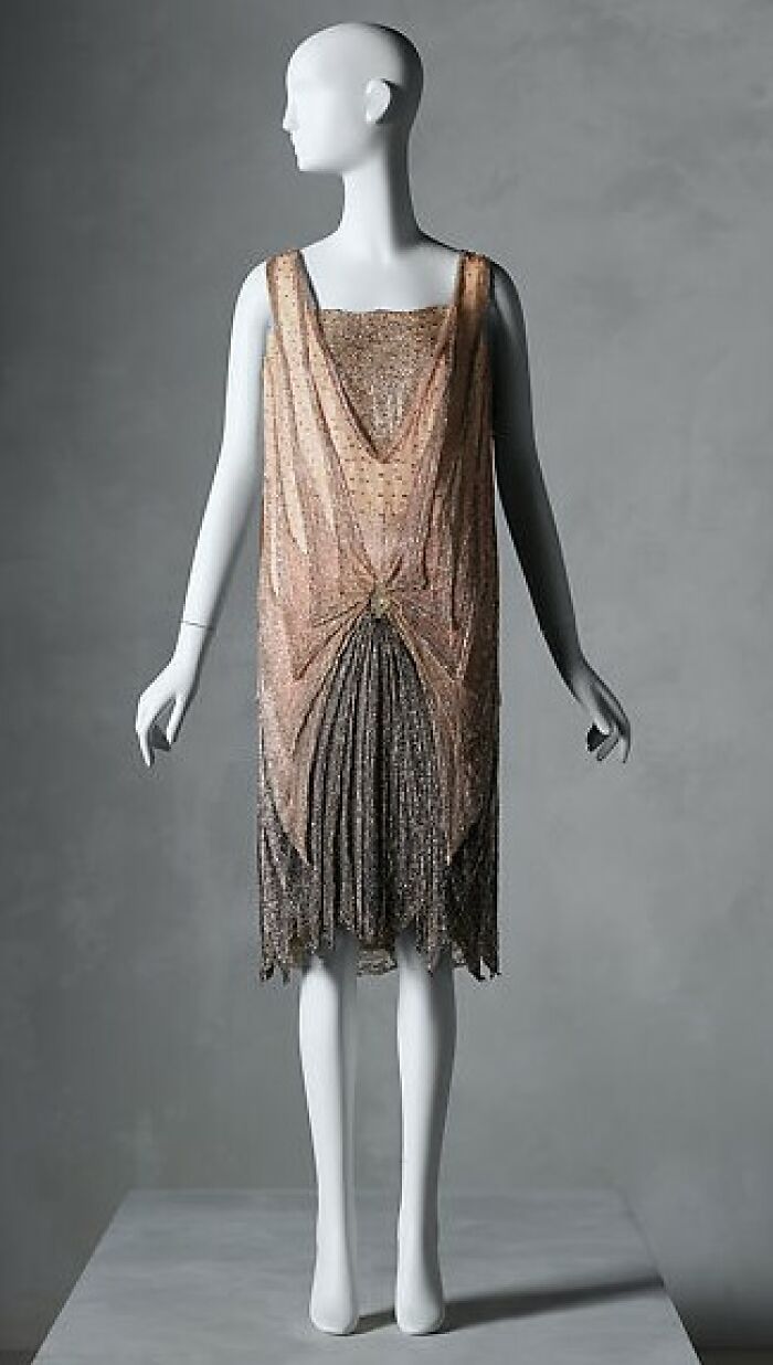 Vintage sleeveless dress displayed on a mannequin capturing culture and everyday life in the past.