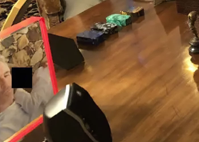 Disturbing Epstein desk photo showing personal items and reflections on wooden surface after Congress estate image release. Disturbing Epstein desk photo showing personal items and reflections on wooden surface after Congress estate image release.