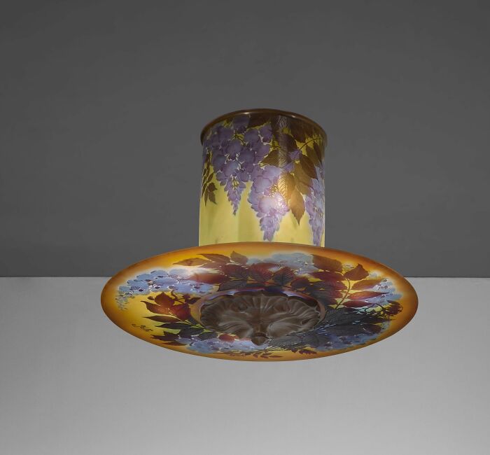 Vintage glass ceiling light fixture with floral design, showcasing culture and everyday life in the past era.