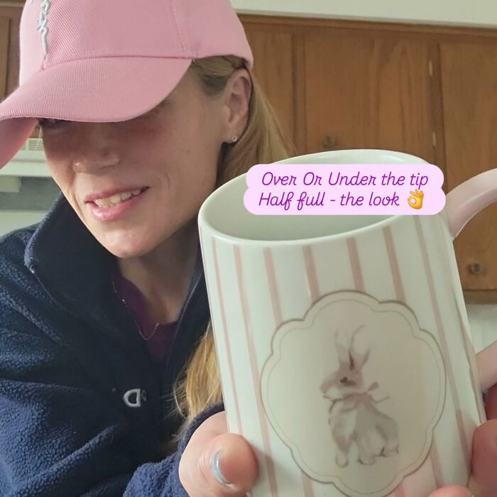 Woman wearing pink cap holding white mug with bunny design, related to racist Cinnabon employee GoFundMe incident. Woman wearing pink cap holding white mug with bunny design, related to racist Cinnabon employee GoFundMe incident.