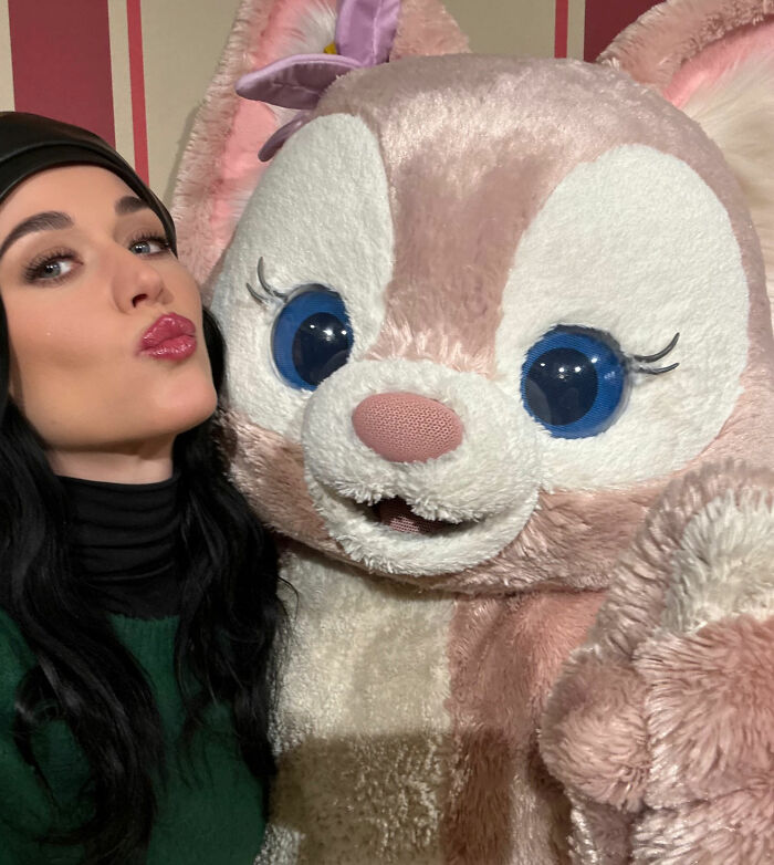 Woman posing with a large pink and white plush character, unrelated to Justin Trudeau and Japan's Ex-PM meeting. Woman posing with a large pink and white plush character, unrelated to Justin Trudeau and Japan's Ex-PM meeting.
