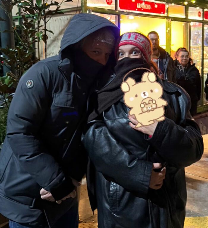 People outside a store at night with faces partially covered, linked to viral theory about Millie Bobby Brown’s newborn daughter. People outside a store at night with faces partially covered, linked to viral theory about Millie Bobby Brown’s newborn daughter.