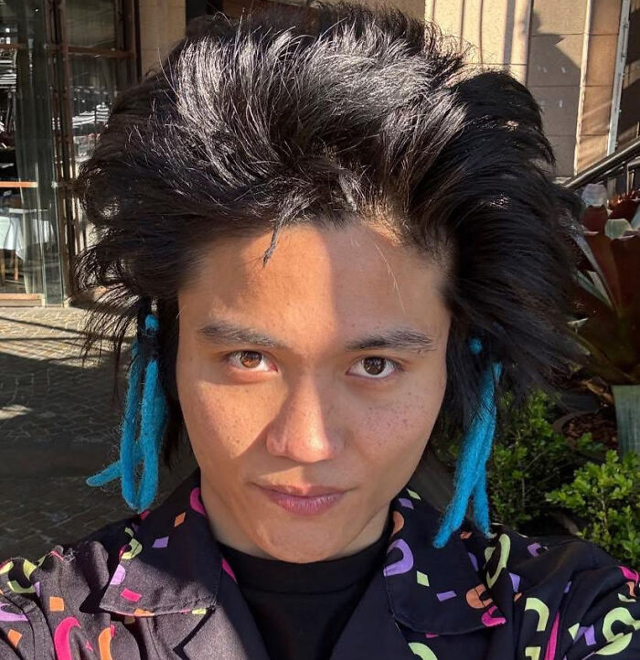 Man with black and blue dreadlocks in colorful shirt, representing a real danger jailed for attacking Ariana Grande.