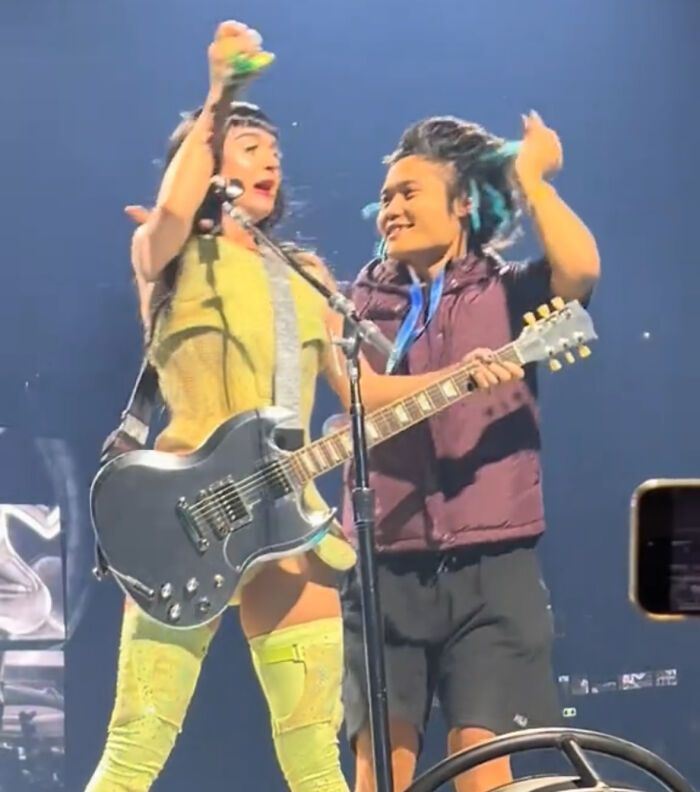 Lady Gaga performing on stage with guitar during concert, highlighting a jailed man&rsquo;s trouble at the event.