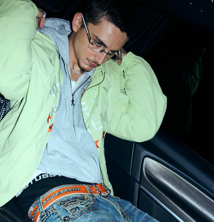 Young man wearing glasses and a green jacket indoors, relating to Timothée Chalamet and Love Actually misread reactions. Young man wearing glasses and a green jacket indoors, relating to Timothée Chalamet and Love Actually misread reactions.