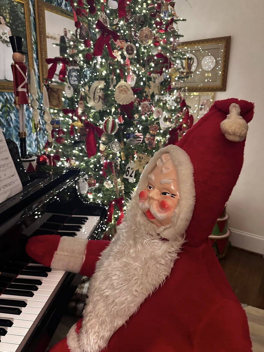 Vintage Christmas decorations featuring a classic Santa figure playing piano beside a decorated tree with nostalgic ornaments and lights.