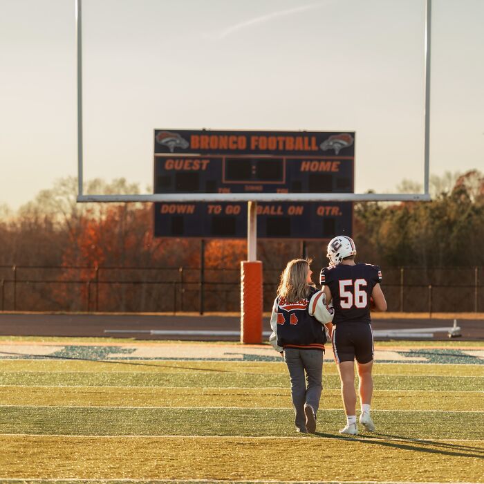 Mother and son walking on football field during photoshoot sparking viral parenting debate about dating own son.