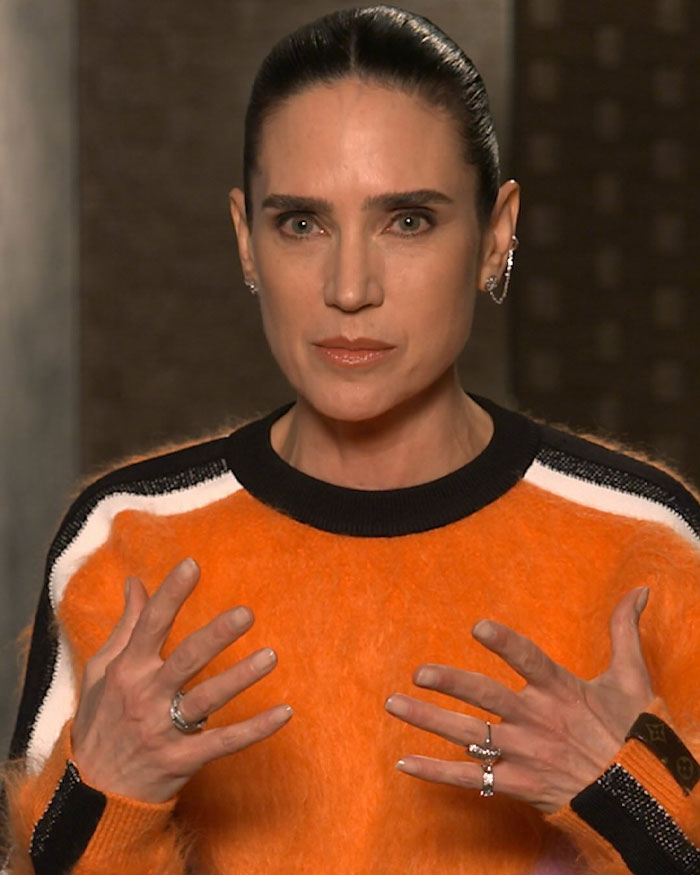 Jennifer Connelly in an orange sweater, discussing her regrets about an iconic movie scene sparking career debate. Jennifer Connelly in an orange sweater, discussing her regrets about an iconic movie scene sparking career debate.