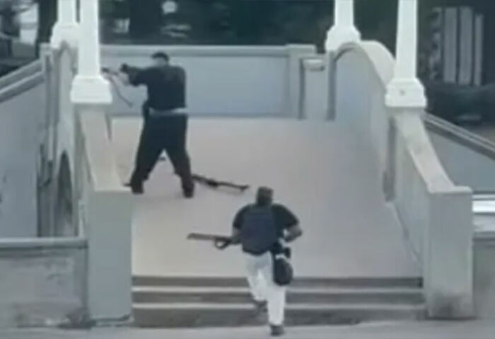 Man disarming attacker on stairs during Hanukkah event near Bondi Beach in a tense security moment. Man disarming attacker on stairs during Hanukkah event near Bondi Beach in a tense security moment.