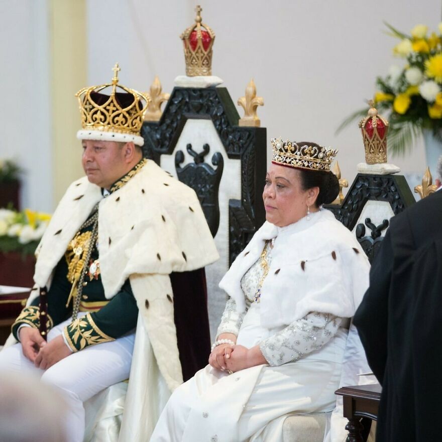 King and queen wearing crowns and robes, seated on thrones representing one of the oldest surviving monarchies.