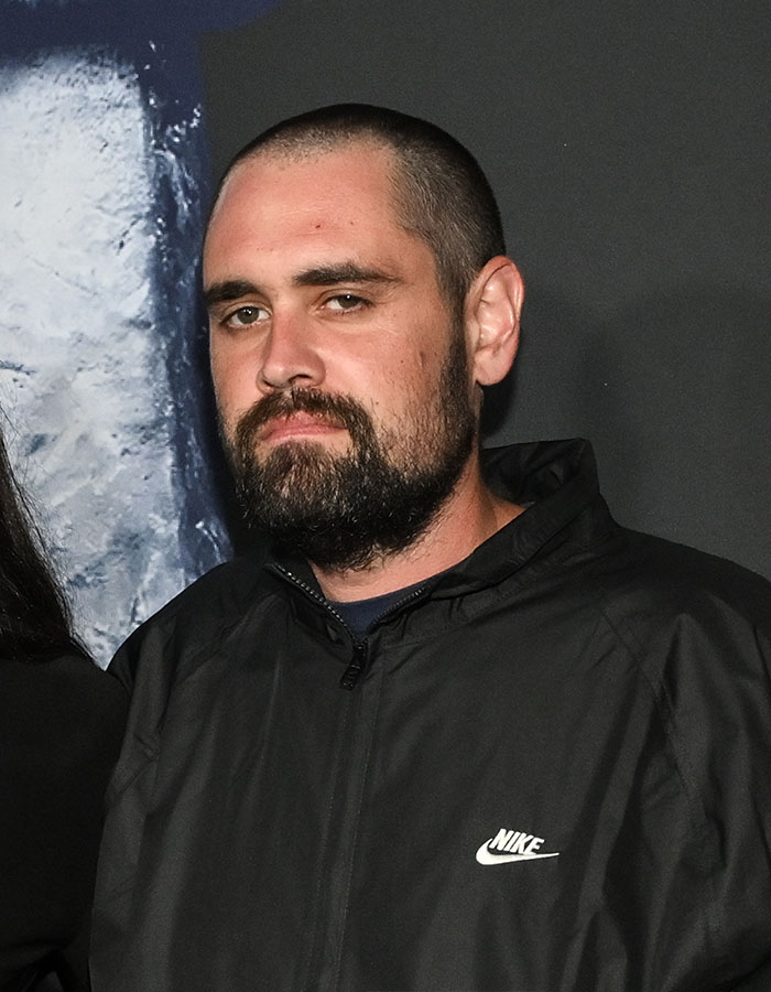 Man with beard and buzz cut wearing a black Nike jacket at an event related to Rob Reiner's son and celebrities topic Man with beard and buzz cut wearing a black Nike jacket at an event related to Rob Reiner's son and celebrities topic
