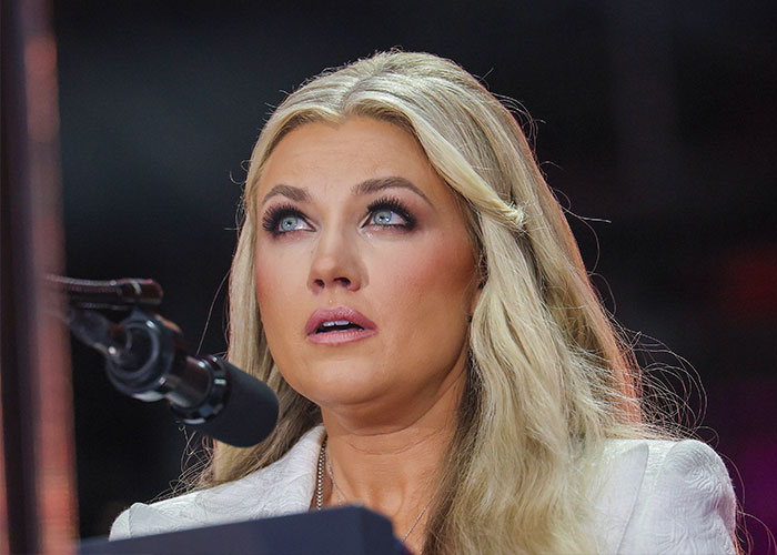 Erika Kirk speaking at a microphone during a public event, highlighted in moment with husband Charlie and body slam clip.