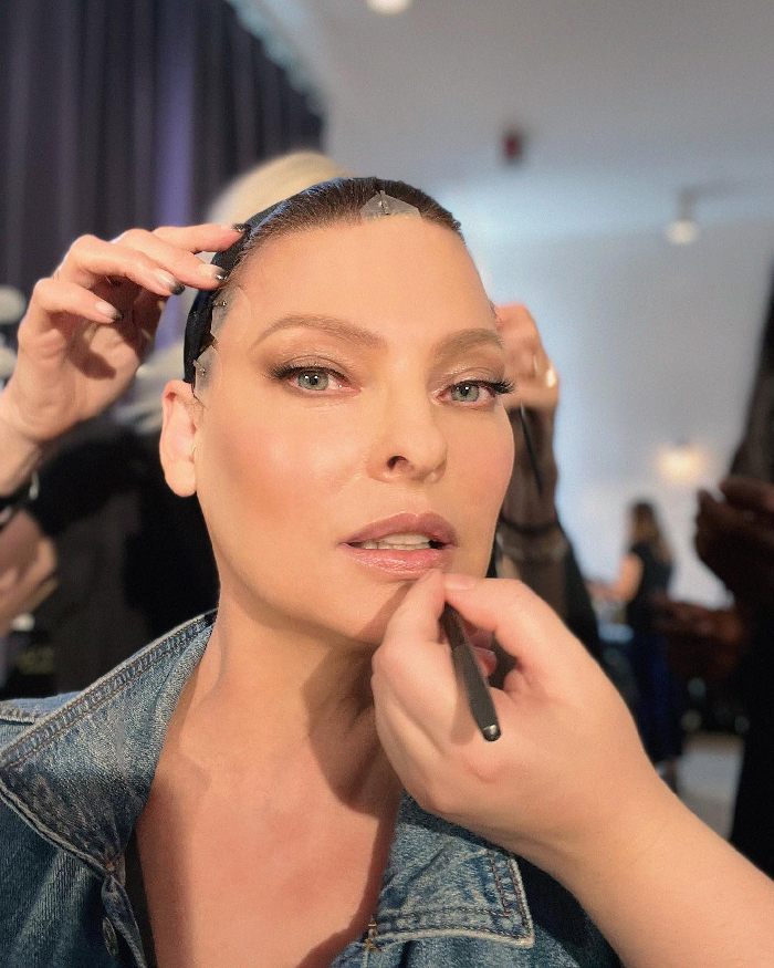 Linda Evangelista having makeup applied during Coolsculpting photoshoot, highlighting beauty and transformation process.