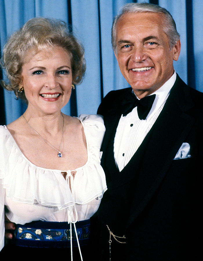 Two 55-year-old celebrities dressed elegantly posing together, prompting debate among surgeons and fans about changes over time.