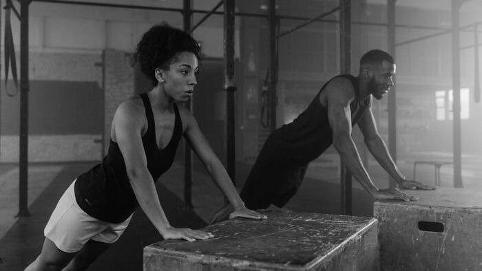 Two people exercising on wooden boxes in a gym, illustrating ambiguous situations to cast your vote for who’s at fault.