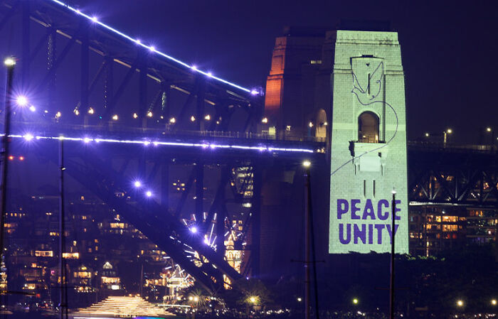 Sydney Harbour Bridge at night with peace and unity projected, highlighting public reaction to New Year’s Eve space reservation. Sydney Harbour Bridge at night with peace and unity projected, highlighting public reaction to New Year’s Eve space reservation.