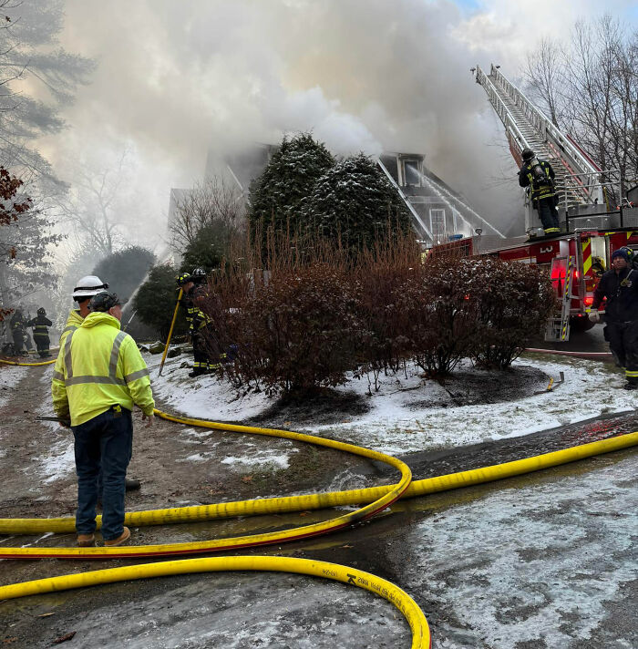 Firefighters work to control a smoke-filled fire at a snowy multi-million dollar mansion during a tragic Christmas Eve accident.