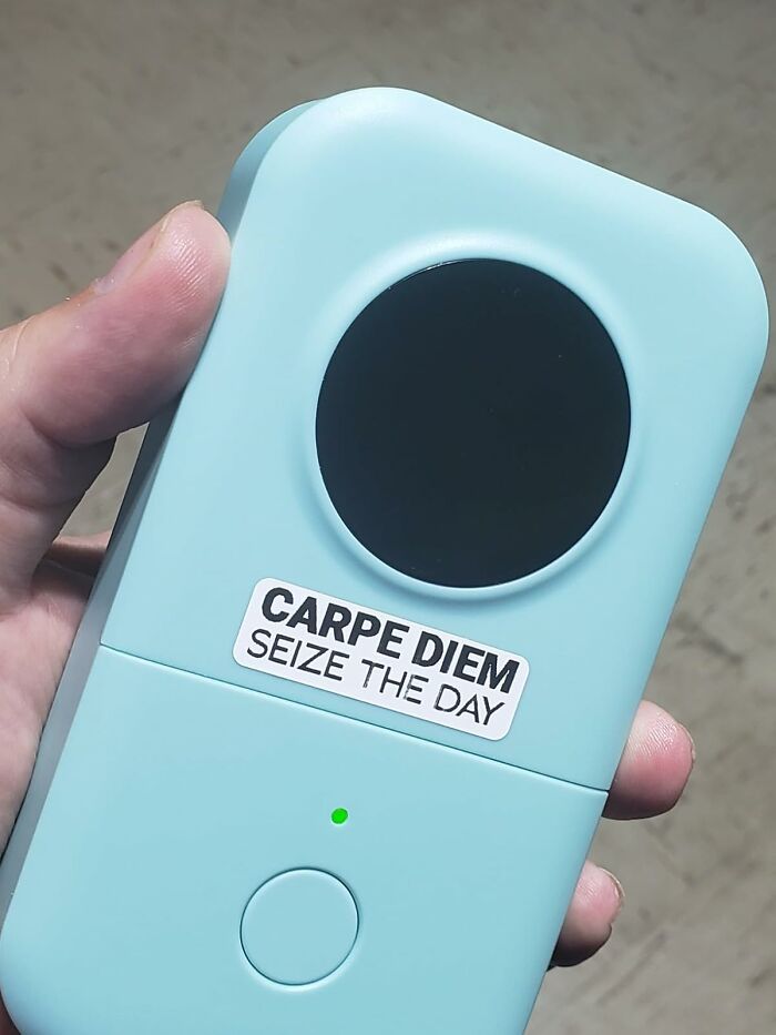 Hand holding a popular Amazon wish list product, a compact blue device with Carpe Diem sticker and a green light.
