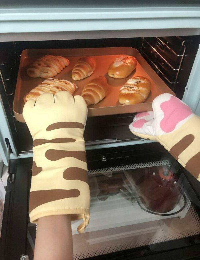 Pulling A 400-Degree Pan From The Oven Can Now Be Done With Paws That Would Clearly Rather Be Napping In A Sunbeam Thanks To These Cat Paw Oven Mitts 