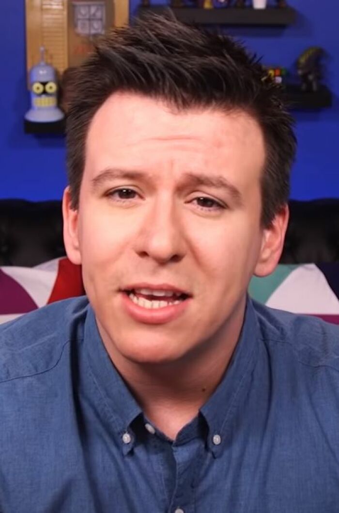 Philip DeFranco speaking directly to the camera in a casual setting with colorful background elements.
