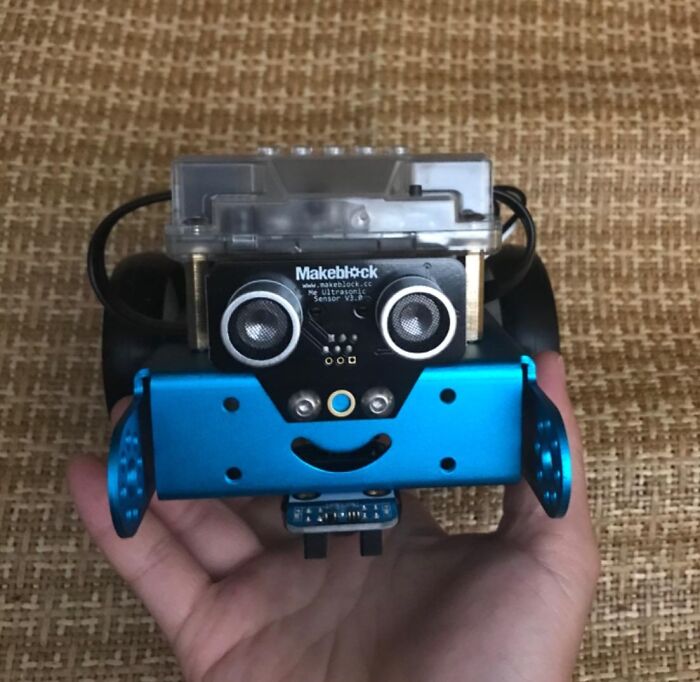 Hand holding a blue and black Makeblock robot, a popular tech gift teens are begging Santa for this year.