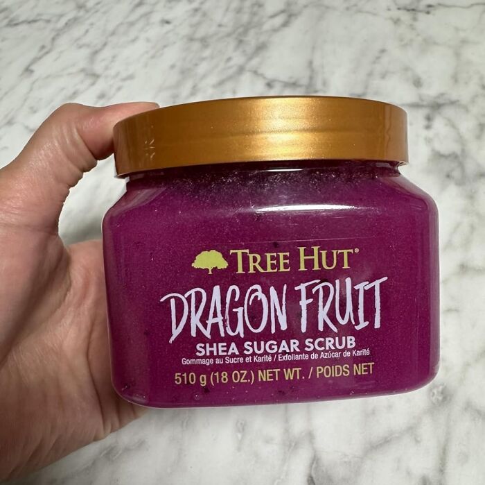 Hand holding Tree Hut Dragon Fruit Shea Sugar Scrub, a popular gift teens are begging Santa for this year.