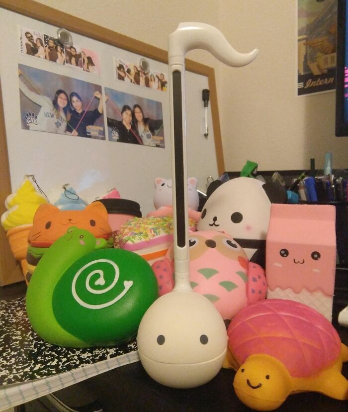 White Otamatone musical toy surrounded by colorful cute squishy toys popular gifts teens are begging Santa for this year.