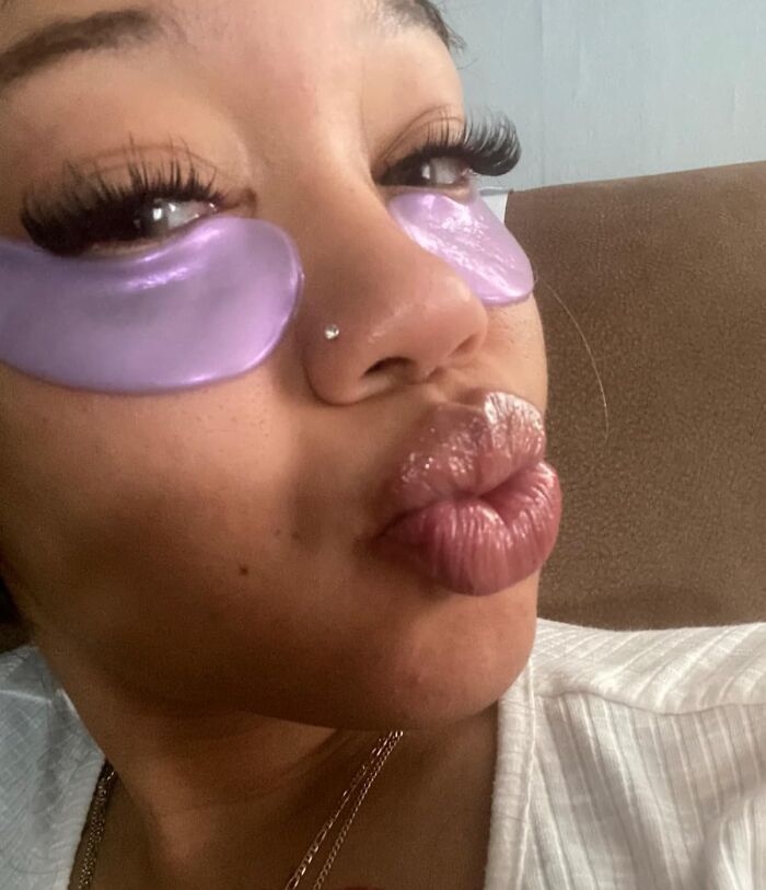 Teen with purple eye masks and glossy lips, showcasing one of the popular gifts that teens are begging for this year.