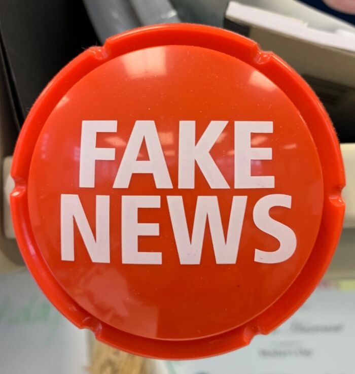 Red novelty button with bold white text reading fake news, quirky gifts for gloriously unhinged friend concept.