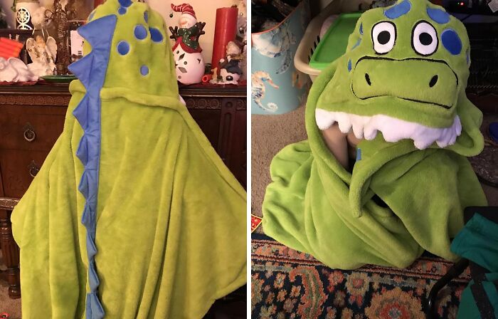 Green dinosaur blanket with blue spikes and dinosaur face hood, a quirky gift for gloriously unhinged taste friends.