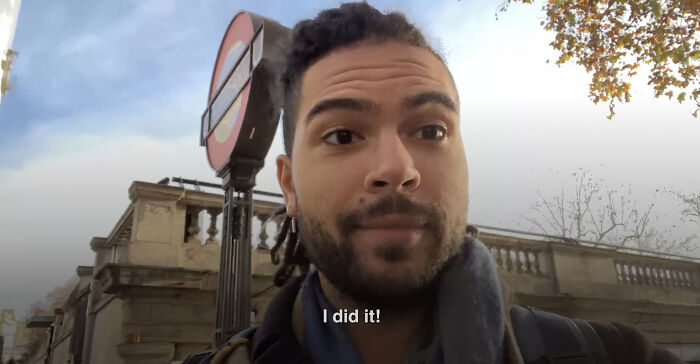 Man with braided hair outdoors near a street sign, expressing achievement, illustrating leap of faith and best life decisions.