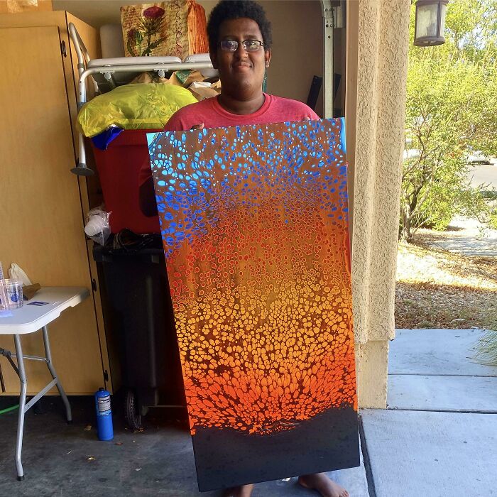 Person holding colorful abstract art painting, showcasing creative leap of faith and best life decisions.