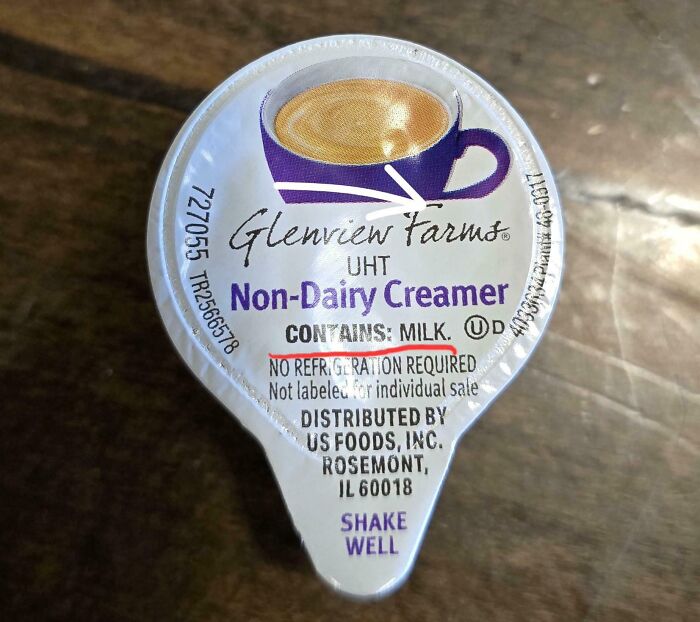 Non-dairy creamer cup labeled as containing milk, highlighting a job done so poorly it is almost impressive.