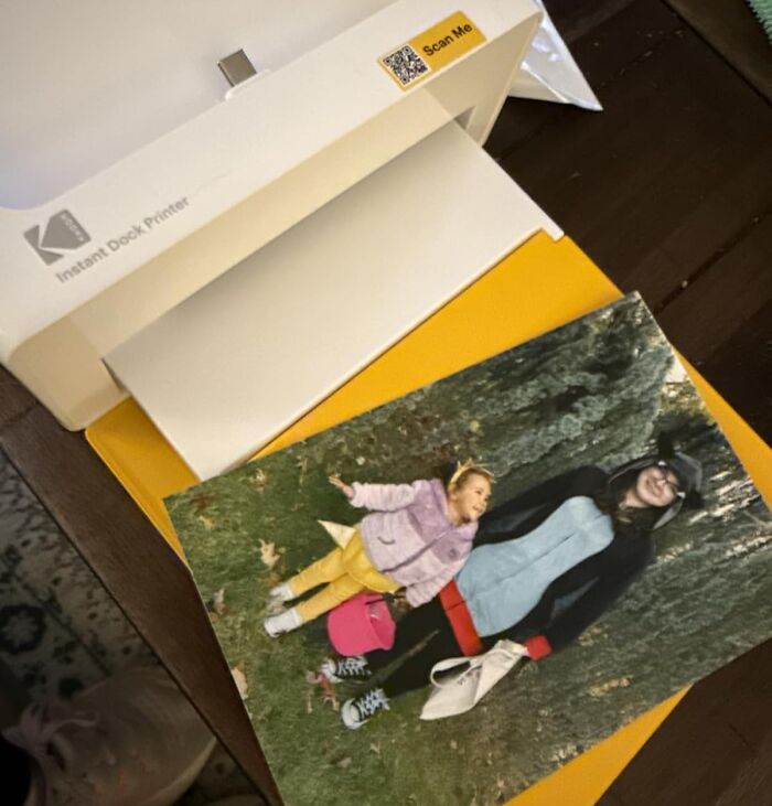 Portable photo printer producing a printed photo, one of the popular products on Amazon wish lists.