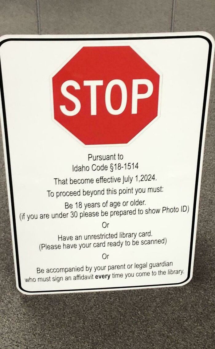 Stop sign with rules in a dystopian setting requiring ID, library card, or guardian affidavit to enter library.