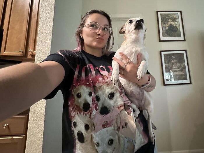 Woman holding a small dog wearing a custom gift t-shirt featuring dog portraits, perfect for Christmas presents.