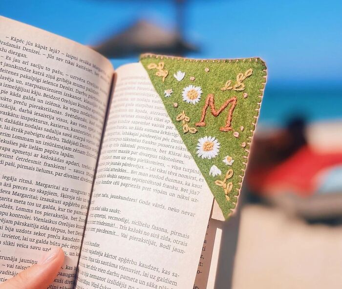 Custom gifts bookmark with embroidered initial and flowers, perfect for unique Christmas gift ideas by the beach setting.