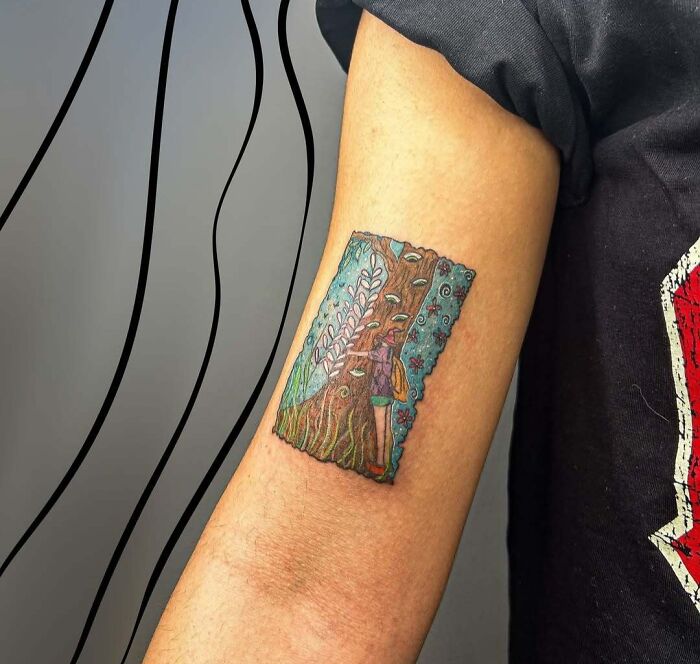 Colorful tattoo of a person hugging a tree on inner arm, showcasing meaningful and wholesome tattoo art with detailed nature elements.