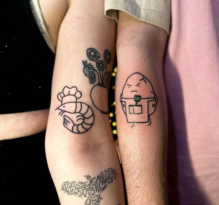 Minimalist wholesome tattoos on forearms featuring a chef shrimp and an angry potato with kitchen tools inked in black.