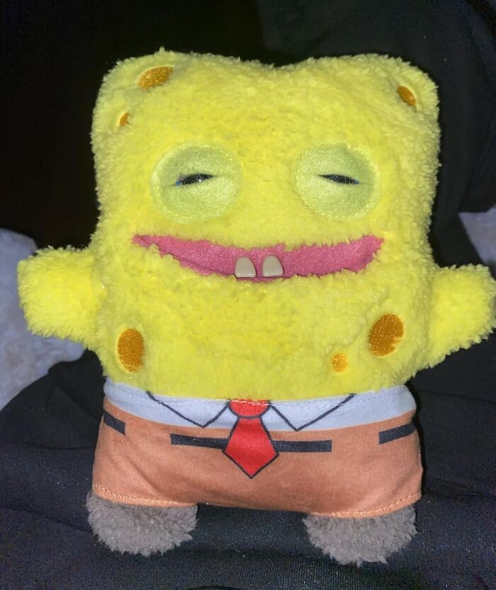 Yellow plush toy with a goofy face and tie, a fun and quirky white elephant gift idea to spark lively stealing.