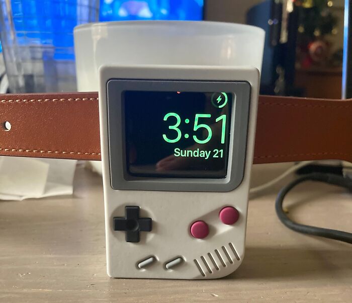 Retro handheld game console Apple Watch stand showing the time, a popular white elephant gift idea for stealing fun.